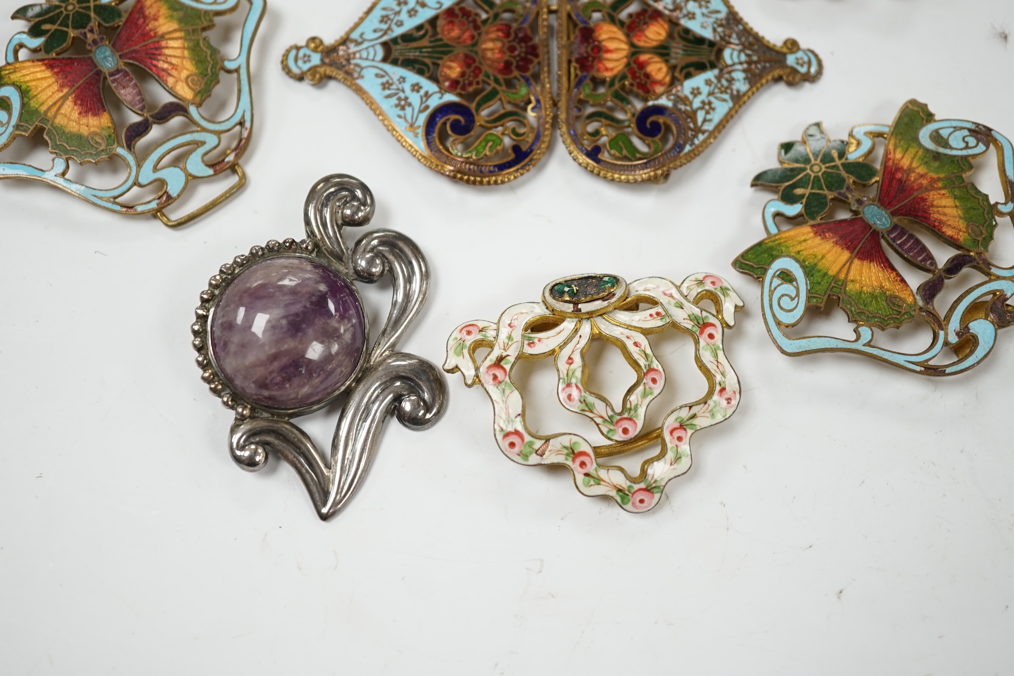A Mexican Los Castillo sterling and cabochon amethyst set foliate brooch, 60mm, a small collection of base metal and cloisonné enamel belt buckles and a cameo brooch. Condition - poor to fair